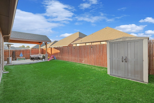 view of yard with outdoor lounge area, a patio, and a shed