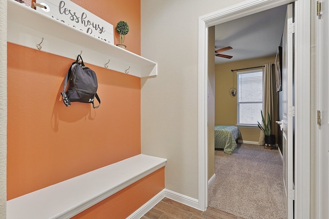 mudroom with light carpet and ceiling fan