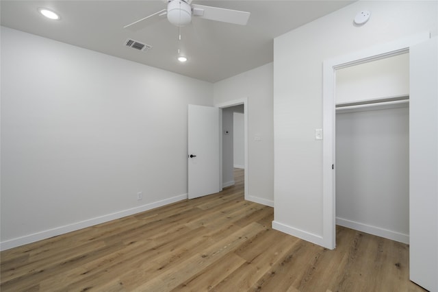 unfurnished bedroom with ceiling fan, light hardwood / wood-style floors, and a closet