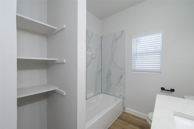 full bathroom with toilet, hardwood / wood-style floors, vanity, and tiled shower / bath