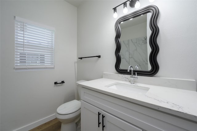 bathroom featuring hardwood / wood-style floors, vanity, and toilet