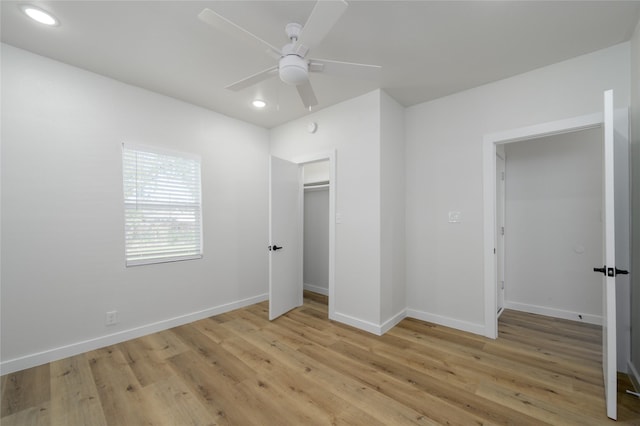 unfurnished bedroom featuring a closet, light hardwood / wood-style floors, and ceiling fan