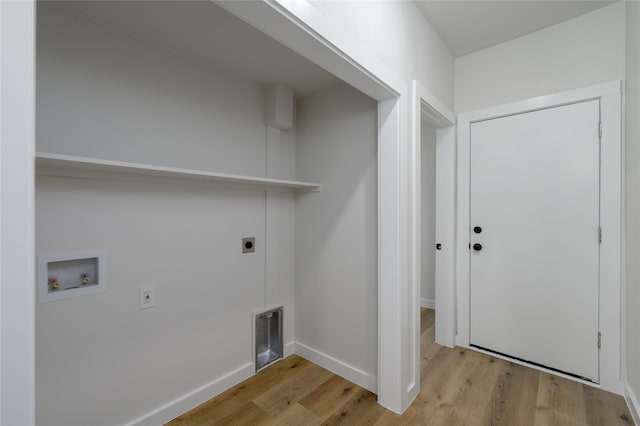 washroom featuring electric dryer hookup, light hardwood / wood-style flooring, and washer hookup