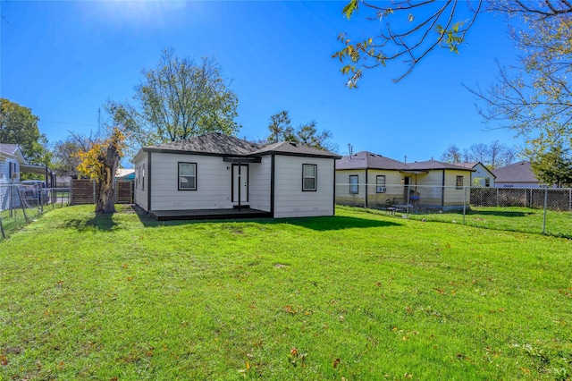 rear view of property with a lawn