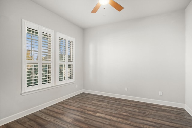 empty room with dark wood-type flooring and ceiling fan