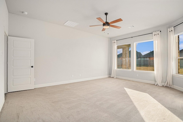 carpeted spare room with ceiling fan