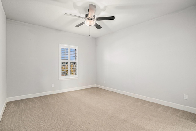 carpeted empty room featuring ceiling fan