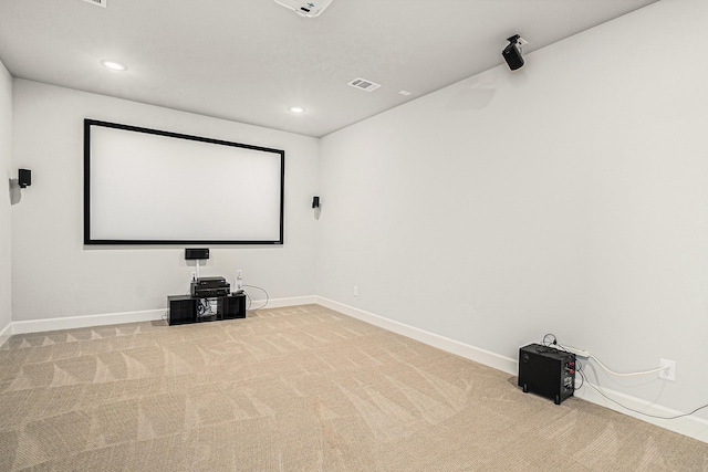 cinema room featuring light carpet