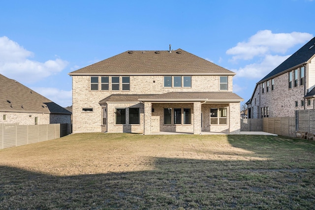 back of property featuring a yard and a patio area