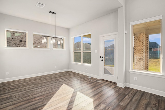 unfurnished dining area featuring dark wood-type flooring