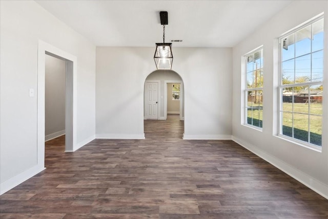 unfurnished dining area featuring dark wood-type flooring