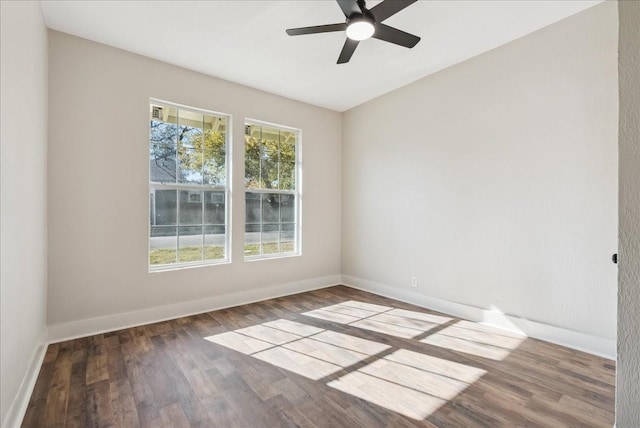 unfurnished room with dark wood-type flooring and ceiling fan