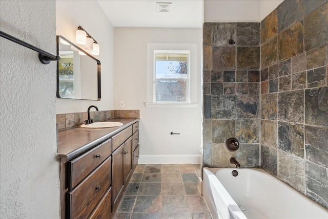 bathroom with vanity and tiled shower / bath