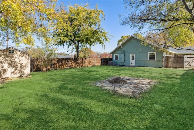 view of yard featuring a storage unit and a fire pit