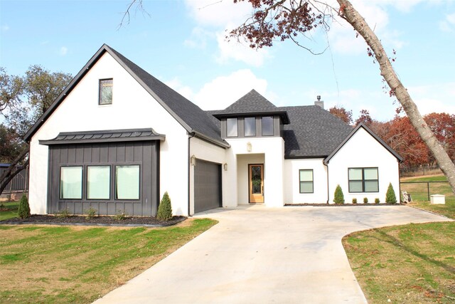 modern farmhouse style home featuring a garage and a front yard