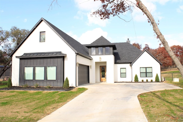 modern farmhouse style home with a garage and a front lawn