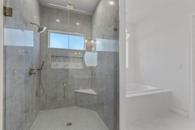 bathroom with shower with separate bathtub and tile patterned floors