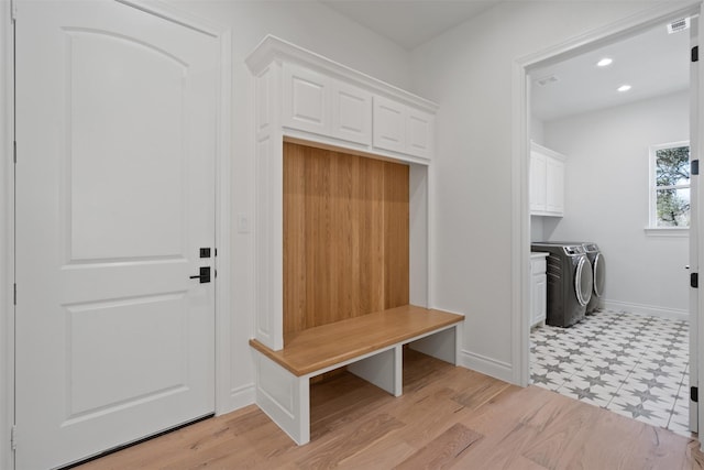 mudroom featuring washer and dryer and light hardwood / wood-style flooring