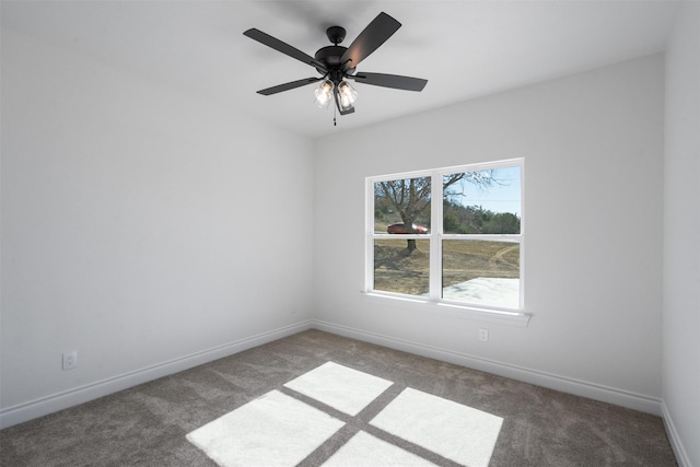 unfurnished room with dark colored carpet and ceiling fan