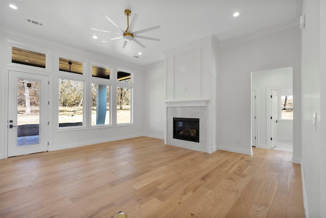 unfurnished living room featuring crown molding, ceiling fan, and light hardwood / wood-style floors