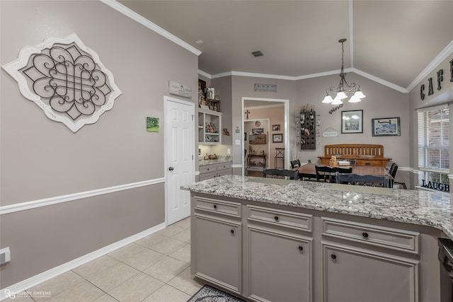 kitchen featuring pendant lighting, crown molding, vaulted ceiling, light tile patterned floors, and a notable chandelier