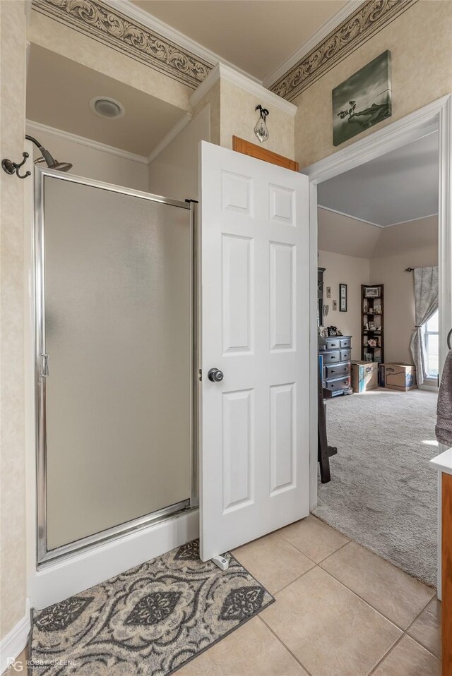 bathroom featuring tile patterned floors, walk in shower, and ornamental molding