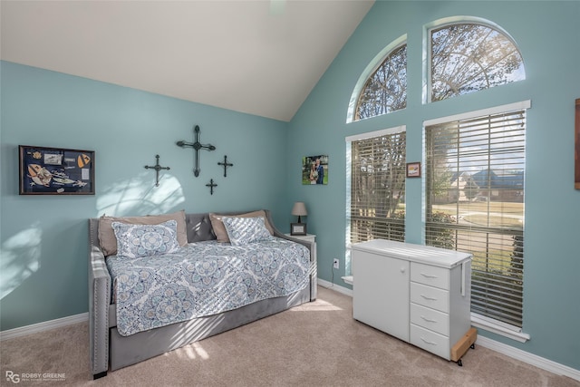 carpeted bedroom featuring high vaulted ceiling