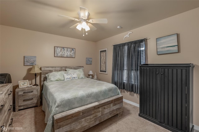 bedroom with ceiling fan and light carpet