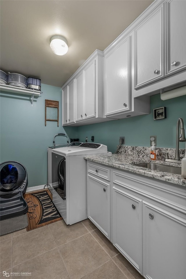 clothes washing area featuring sink, light tile patterned floors, cabinets, and independent washer and dryer