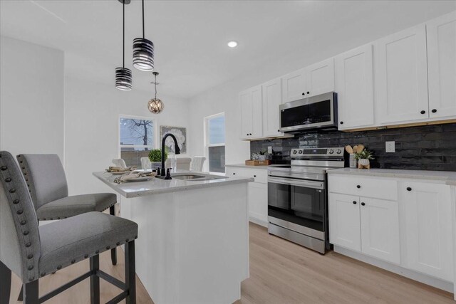 full bathroom featuring hardwood / wood-style floors, vanity, toilet, and tiled shower / bath