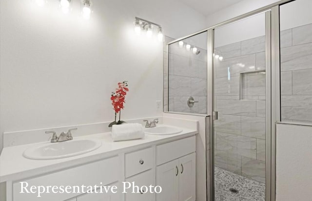 bathroom with a shower with door and vanity