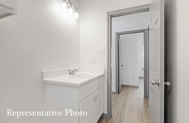 bathroom with hardwood / wood-style flooring and vanity