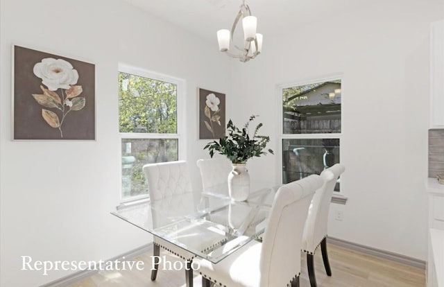 dining room featuring an inviting chandelier and light hardwood / wood-style floors