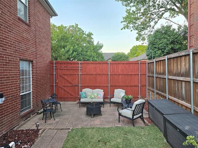 view of patio / terrace featuring an outdoor living space with a fire pit