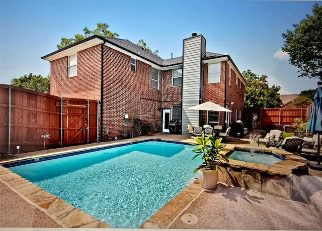 view of pool featuring an in ground hot tub and a patio