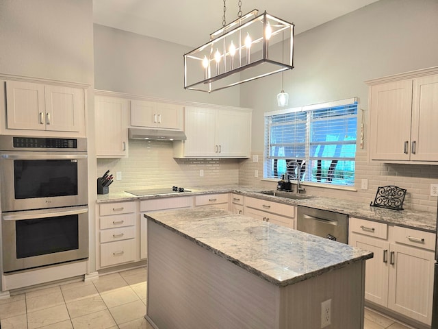 kitchen featuring white cabinetry, sink, a center island, stainless steel appliances, and hanging light fixtures