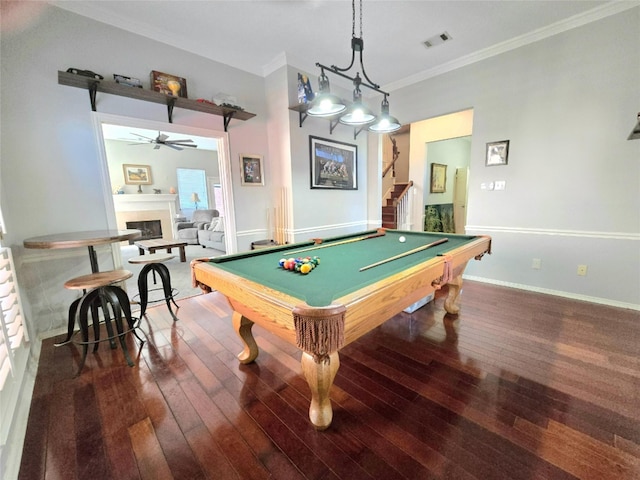 rec room featuring ceiling fan, ornamental molding, dark wood-type flooring, and billiards