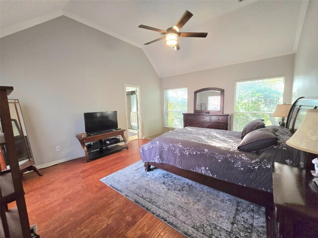 bedroom featuring hardwood / wood-style floors, ceiling fan, lofted ceiling, and crown molding