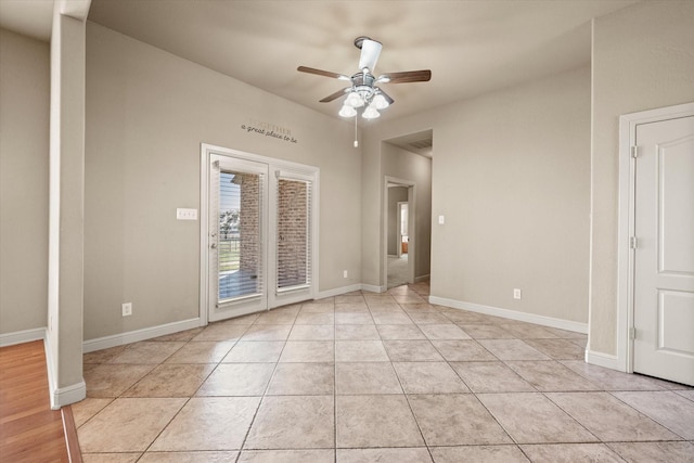 tiled spare room with ceiling fan