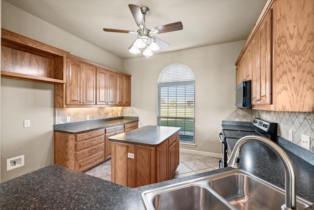 kitchen with backsplash, sink, a center island, and light tile patterned flooring