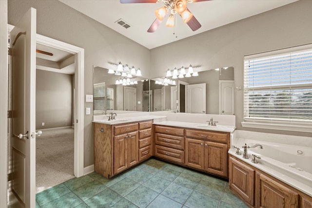 bathroom with a bathing tub, ceiling fan, tile patterned flooring, and vanity