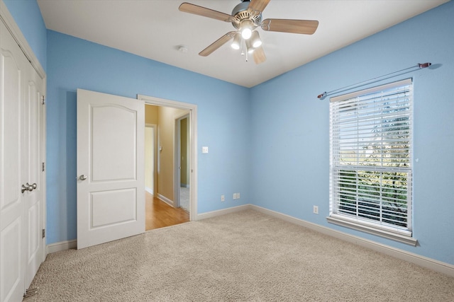 unfurnished bedroom with ceiling fan, a closet, and light colored carpet