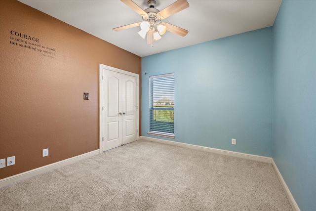 carpeted empty room with ceiling fan