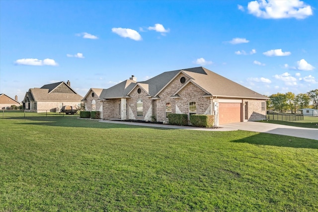 view of front of property featuring a front lawn and a garage