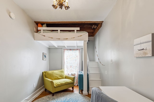 bedroom featuring a chandelier and wood-type flooring