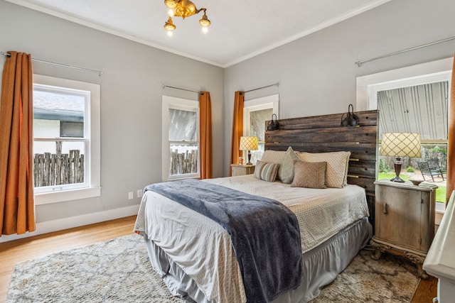 bedroom featuring light wood-type flooring and crown molding