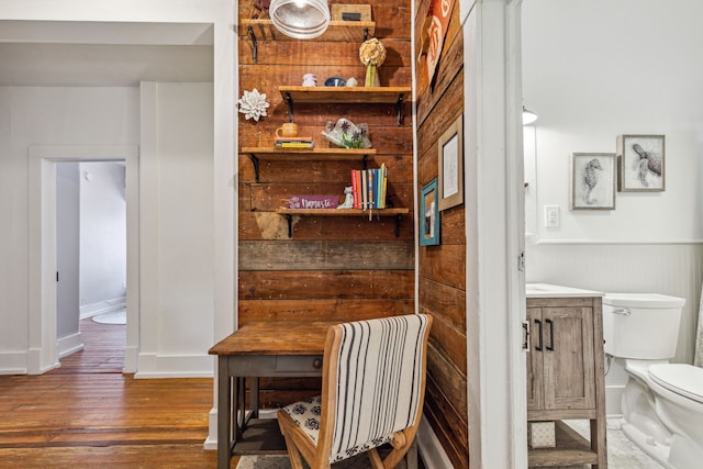 interior space with wooden walls and dark hardwood / wood-style flooring