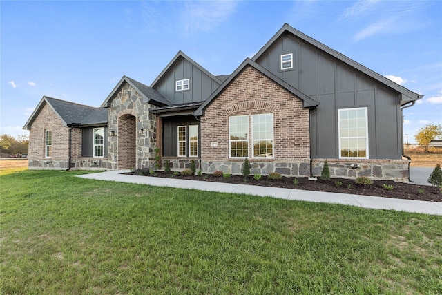 6292 Candy Oak Ct, Royse City, TX 75189 - view of front of home with board and batten siding, stone siding, a front lawn, and brick siding