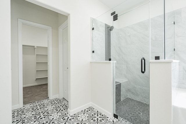 bathroom with tile patterned floors and a shower with door