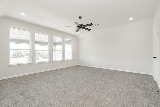 empty room with carpet floors, vaulted ceiling, and ceiling fan